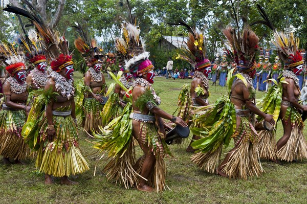 Tribal members in colourful decorations and face paint are celebrating at the traditional Sing Sing gathering in the highlands