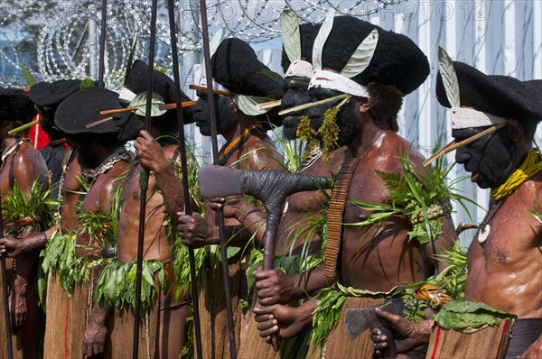 Members of a tribe in colourfully decorated costumes with face paint at the traditional sing-sing gathering