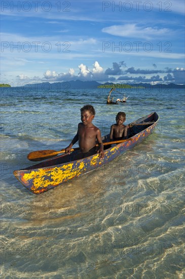 Boys in a canoe in the Marovo Lagoon