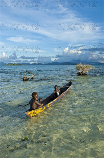 Boys in a canoe in the Marovo Lagoon