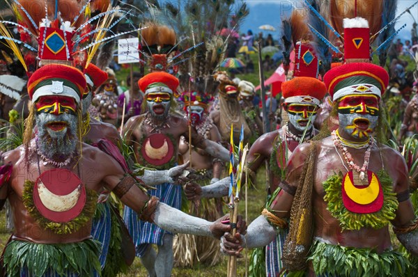 Members of a tribe in colourfully decorated costumes with face paint at the traditional sing-sing gathering