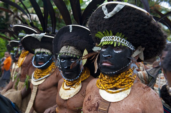 Black decorated and painted tribesmen celebrating the traditional Sing Sing in the highlands