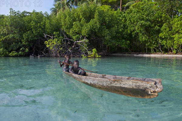 Local boys in a canoe in the Marovo Lagoon