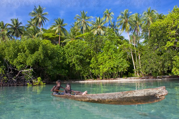 Local boys in a canoe in the Marovo Lagoon