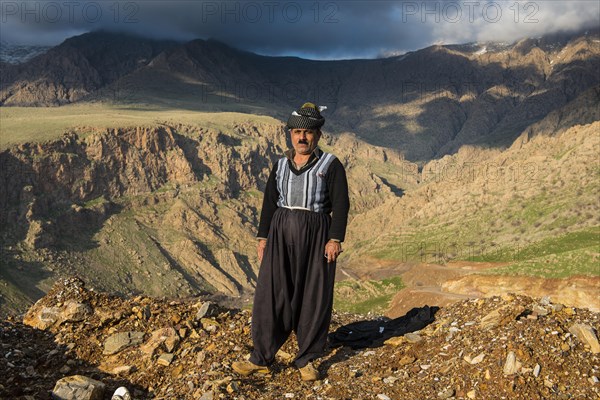 Kurdish shepherd standing on the edge of a canyon right above Ahmed Awa