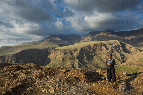 Kurdish shepherd standing on the edge of a canyon right above Ahmed Awa