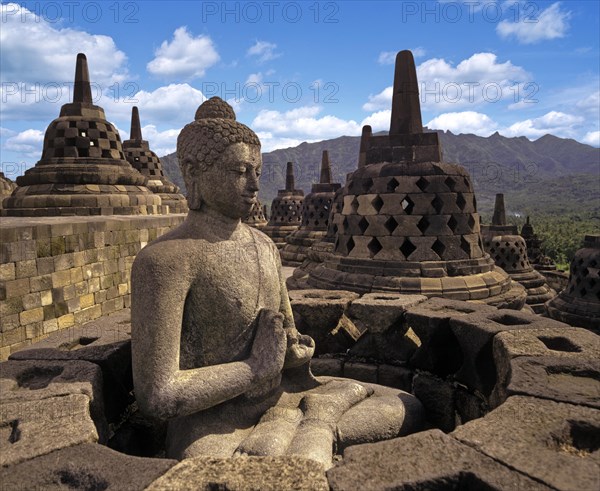 Exposed Buddha statue in the temple complex of Borobudur