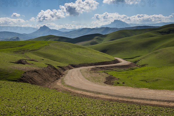 Road sneaking through the green hilly landscape