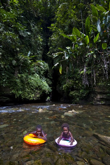 Children bathing in front of the Millennium Cave