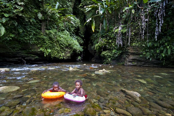 Children bathing in front of the Millennium Cave