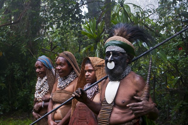 Tribal chief and three women wearing traditional dresses