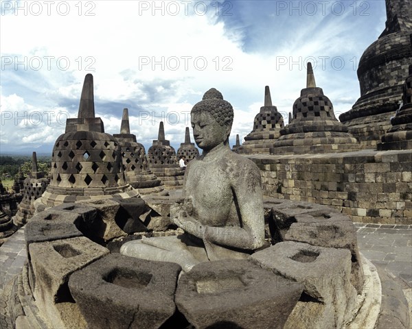 Exposed Buddha statue in the temple complex of Borobudur