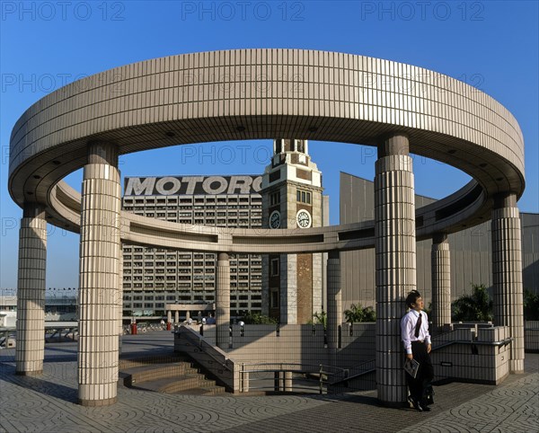 Man leaning against a pillar on a round structure at the Cultural Centre