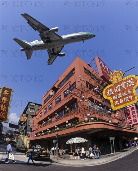 Cathay Pacific aircraft approaching Kai Tak Airport over the rooftops of Kowloon