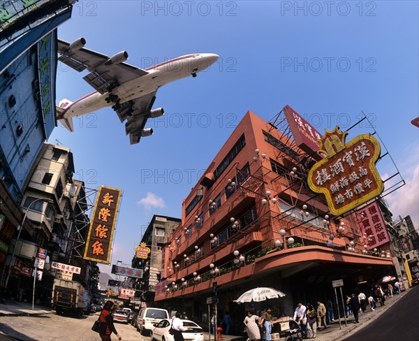 Thai Airways aircraft approaching Kai Tak Airport over the rooftops of Kowloon