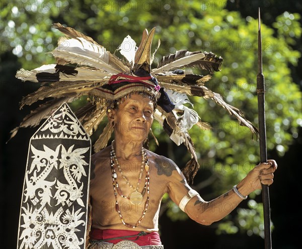 Head hunter of the ethnic group of the Iban people with a spear