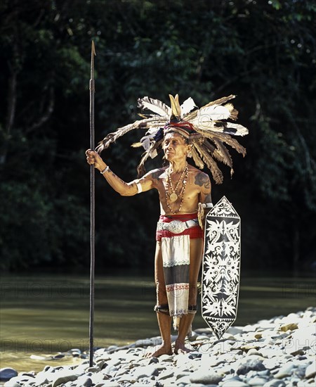Head hunter of the ethnic group of the Iban people with a spear