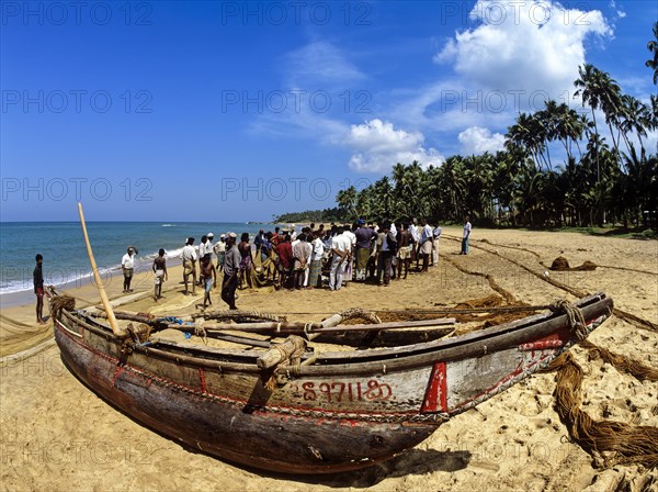 Fishing boat and fishermen on the beach