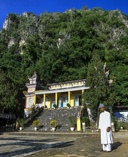 Monk in front of An Quang Pagoda in the Marble Mountains