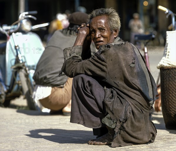 Men of the people of Cham or Tscham people squatting ont he ground