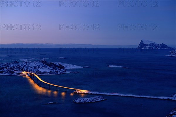 Fjord with a bridge in winter at sunset