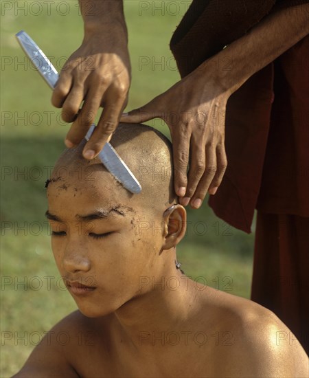 Novice having his hair shaved