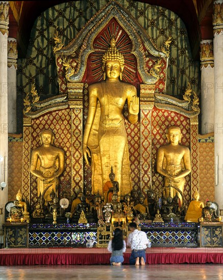 Visitors in front of the Golden Buddha of Wat Chedi Luang Temple