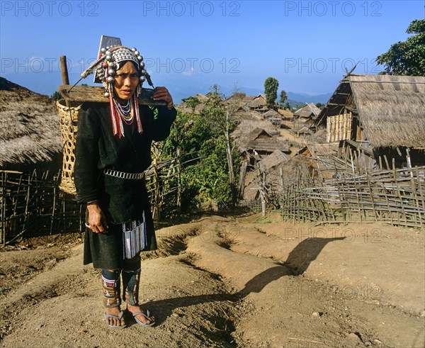 Akha woman in traditional costume with a pannier