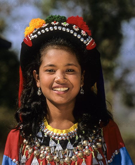 Lisu girl wearing a colourful headdress and the traditional costume of the mountain people