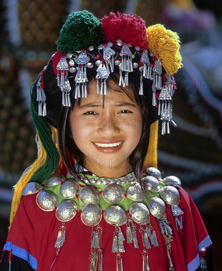 Lisu girl wearing a colourful headdress and the traditional costume of the mountain people