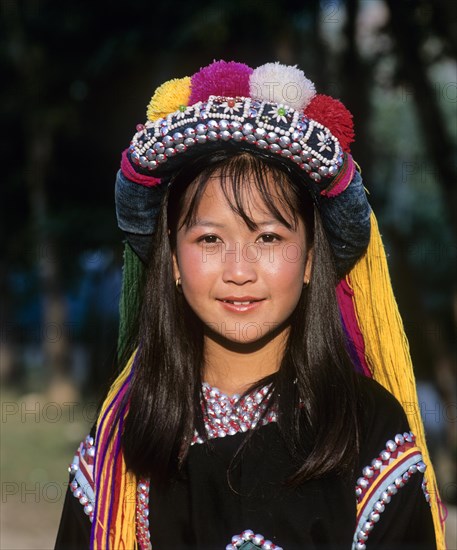 Lisu girl wearing a colourful headdress and the traditional costume of the mountain people