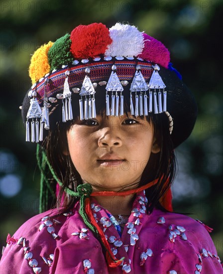 Lisu girl wearing a colourful headdress and the traditional costume of the mountain people