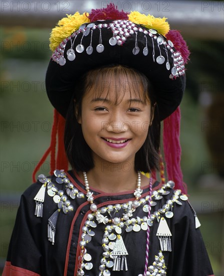 Lisu girl wearing a colourful headdress and the traditional costume of the mountain people