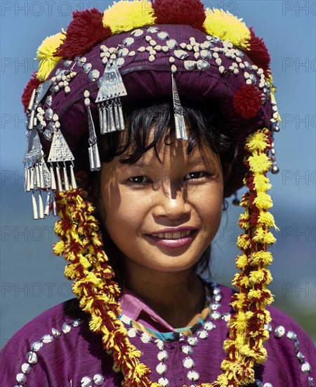 Lisu girl wearing a colourful headdress and the traditional costume of the mountain people