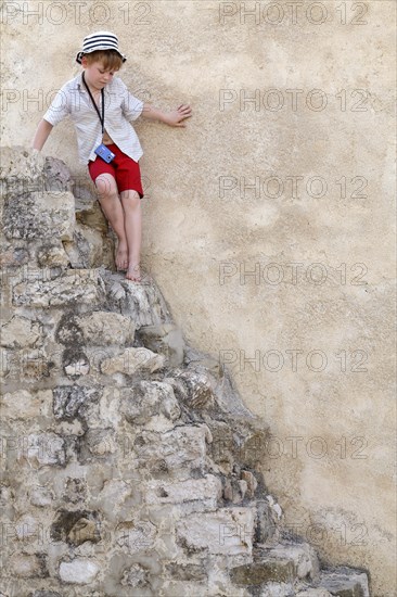Little boy on stone steps