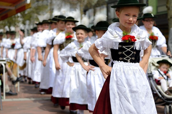 Children wearing traditional costume in a parade