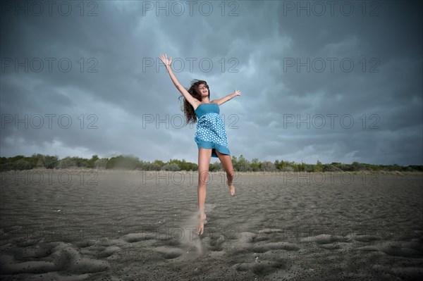 Girl jumping on a beach