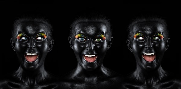 Triple faces of a laughing young woman painted with black facepaint