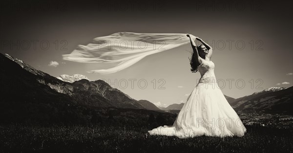 Bride holding a flowing scarf in the Tyrolean Alps