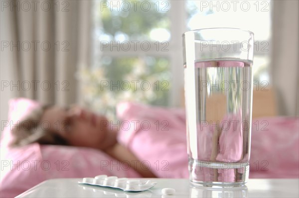 Glass of water with tablets