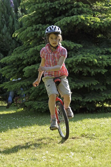 Girl riding a unicycle