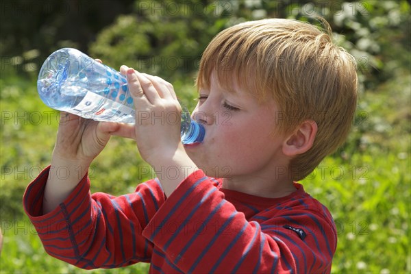 Young boy drinking water