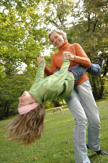 Mother and daughter run around in the park