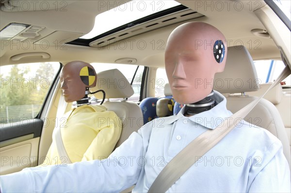 Family of crash test dummies in a car