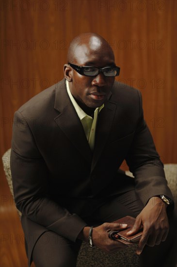 Bald man in a suit with glasses