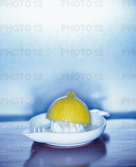 Squeezed lemon in a lemon squeezer