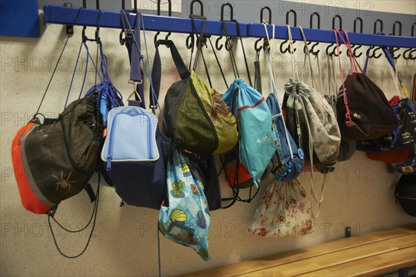 Wardrobe in the school hallway with suspended sports bags