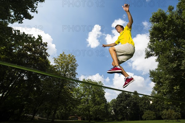 Athlete jumping on a slackline