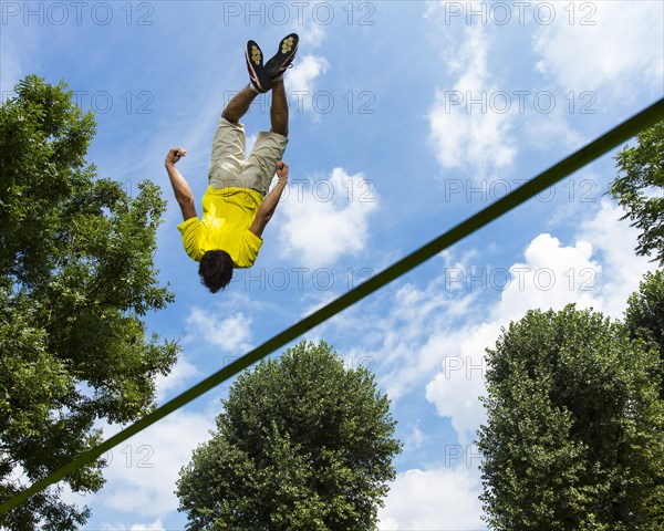 Young man jumping on a slackline