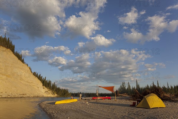 camp with tent and tarp on a gravel bar